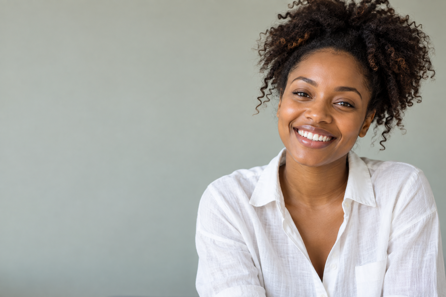 A woman sharing a relaxed, natural smile